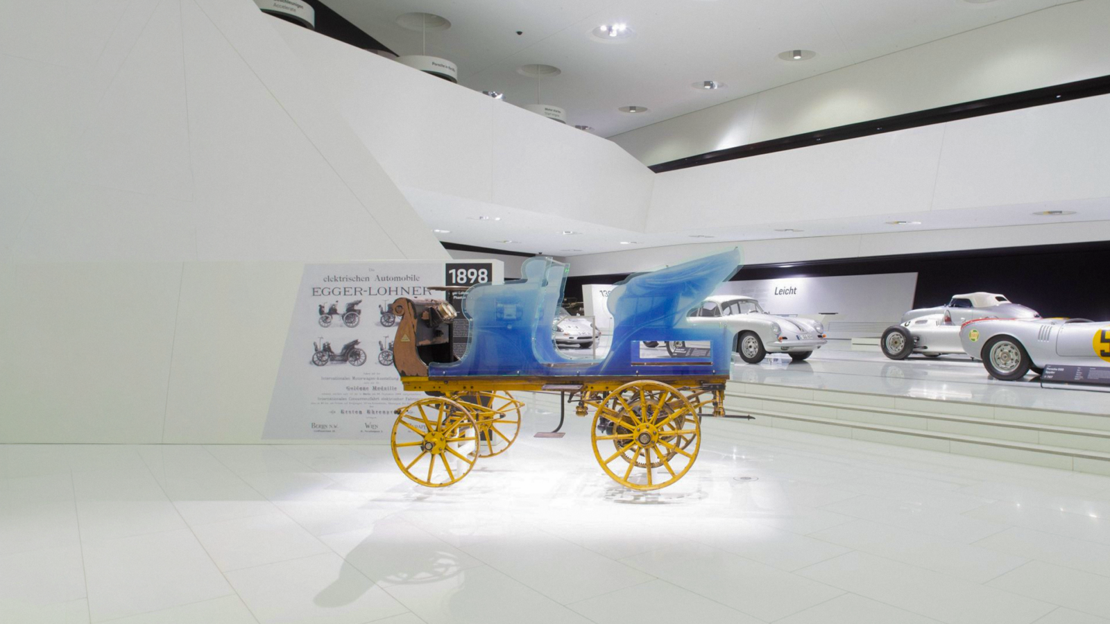 Egger-Lohner C2 Phaeton electric vehicle from 1898 displayed at the Porsche Museum.